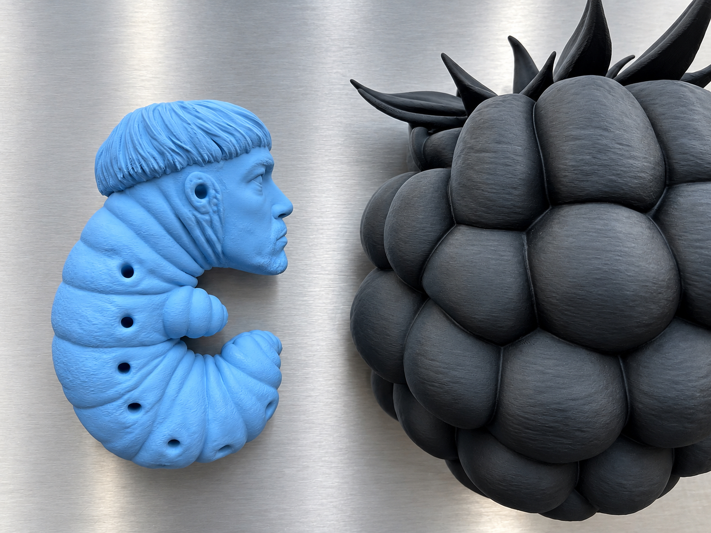 Blue larva beside a black raspberry