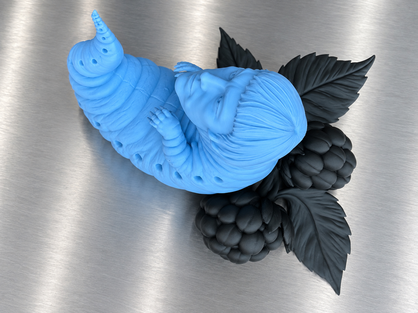 Reclining larval self-portrait on black raspberry leaves