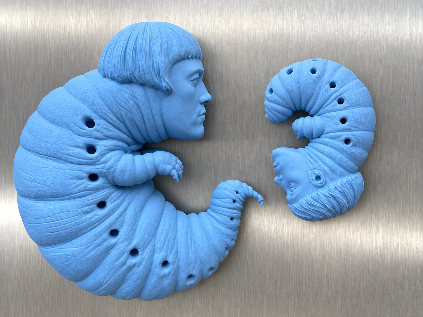 Three blue larval self-portraits on aluminium