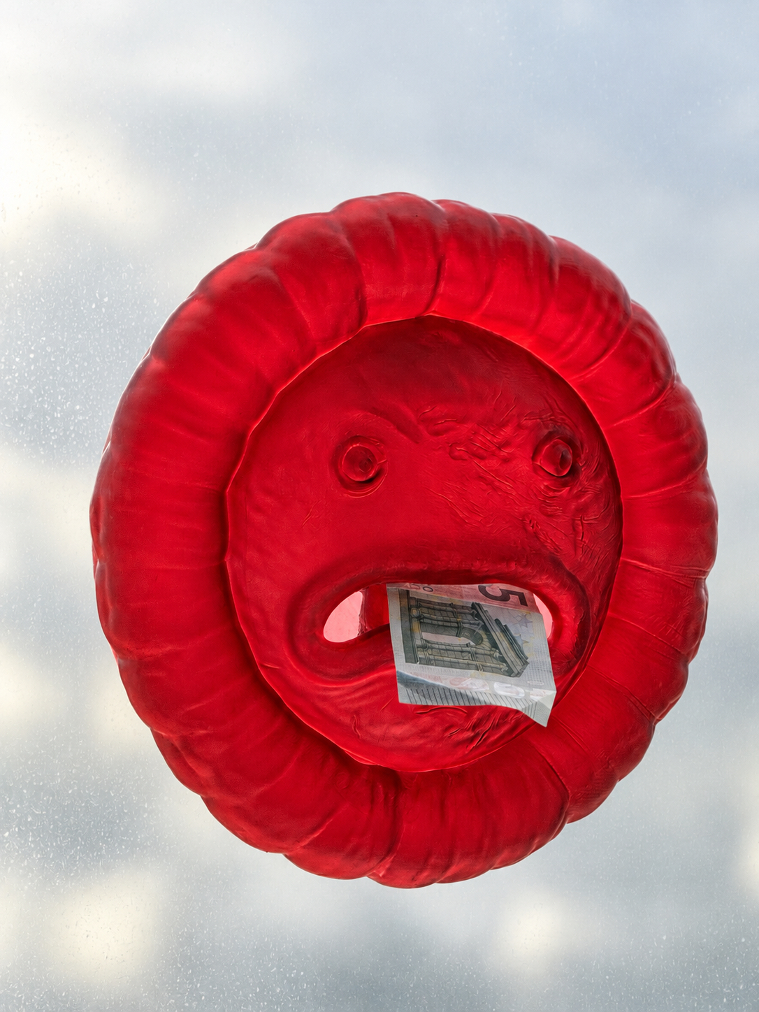 Cashhole holding a banknote in its mouth