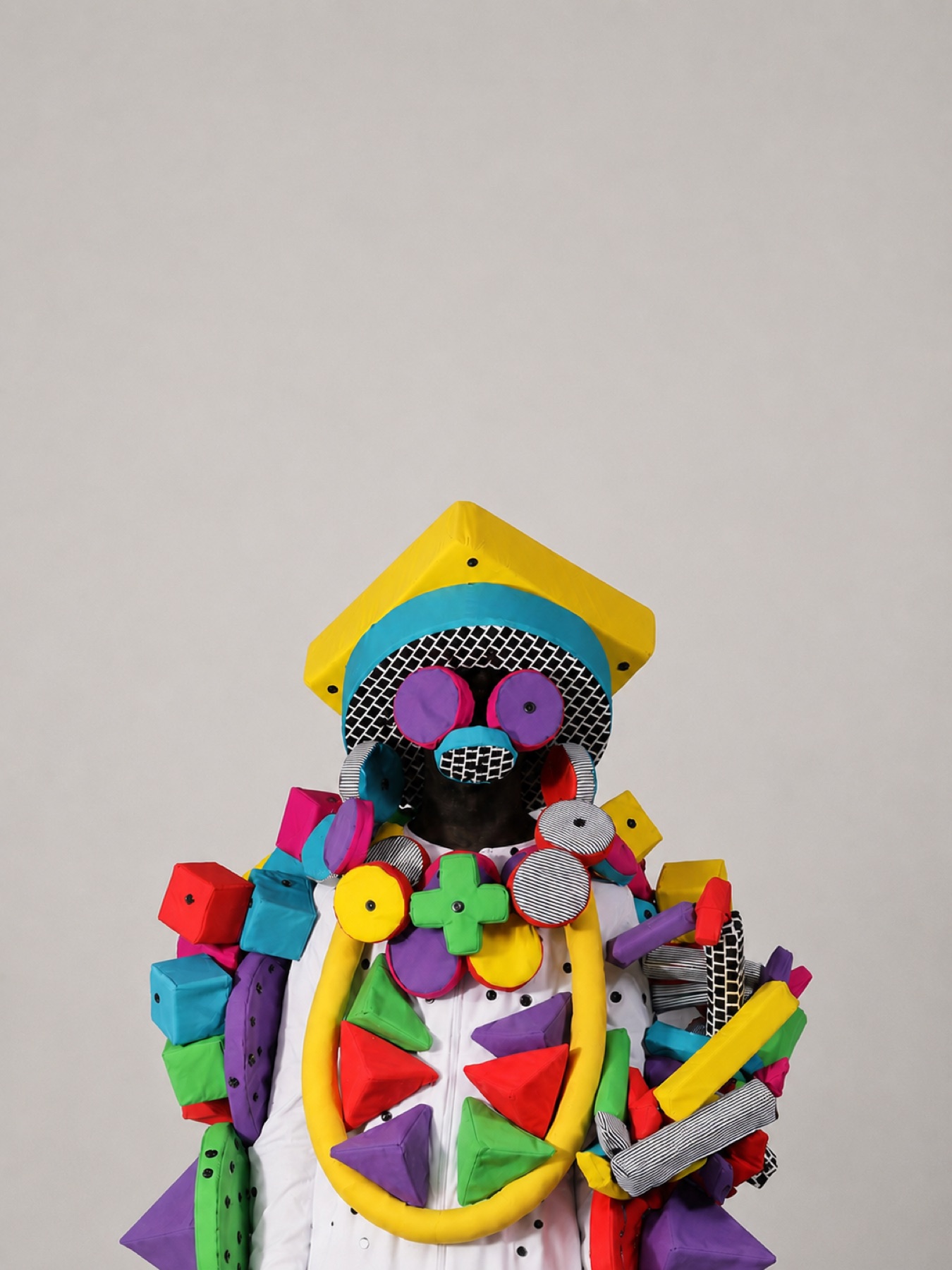 Human Kit wearable sculpture with colorful soft forms arranged on a participant