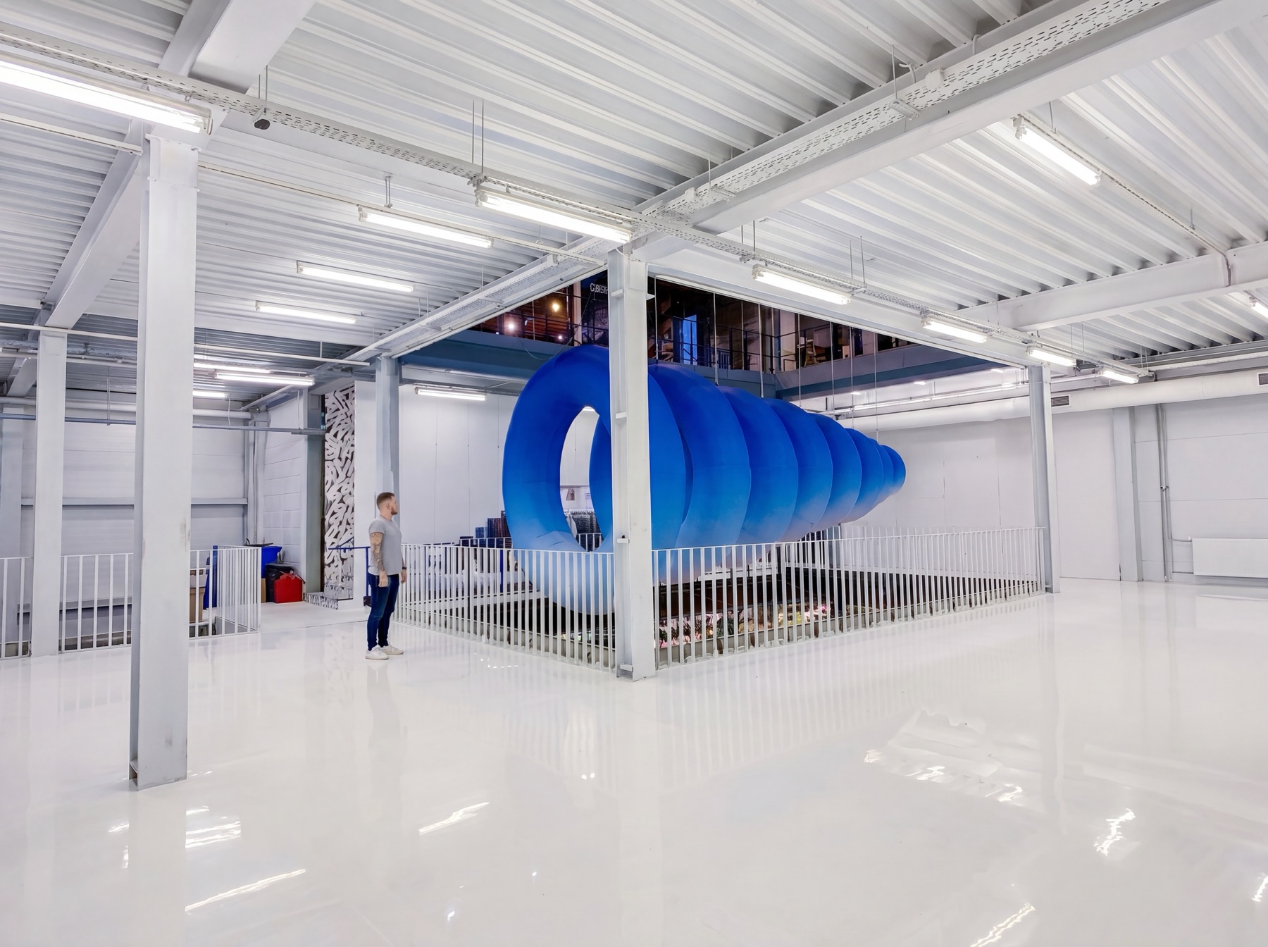 1=0 interactive inflatable installation with a visitor standing beside the blue structure