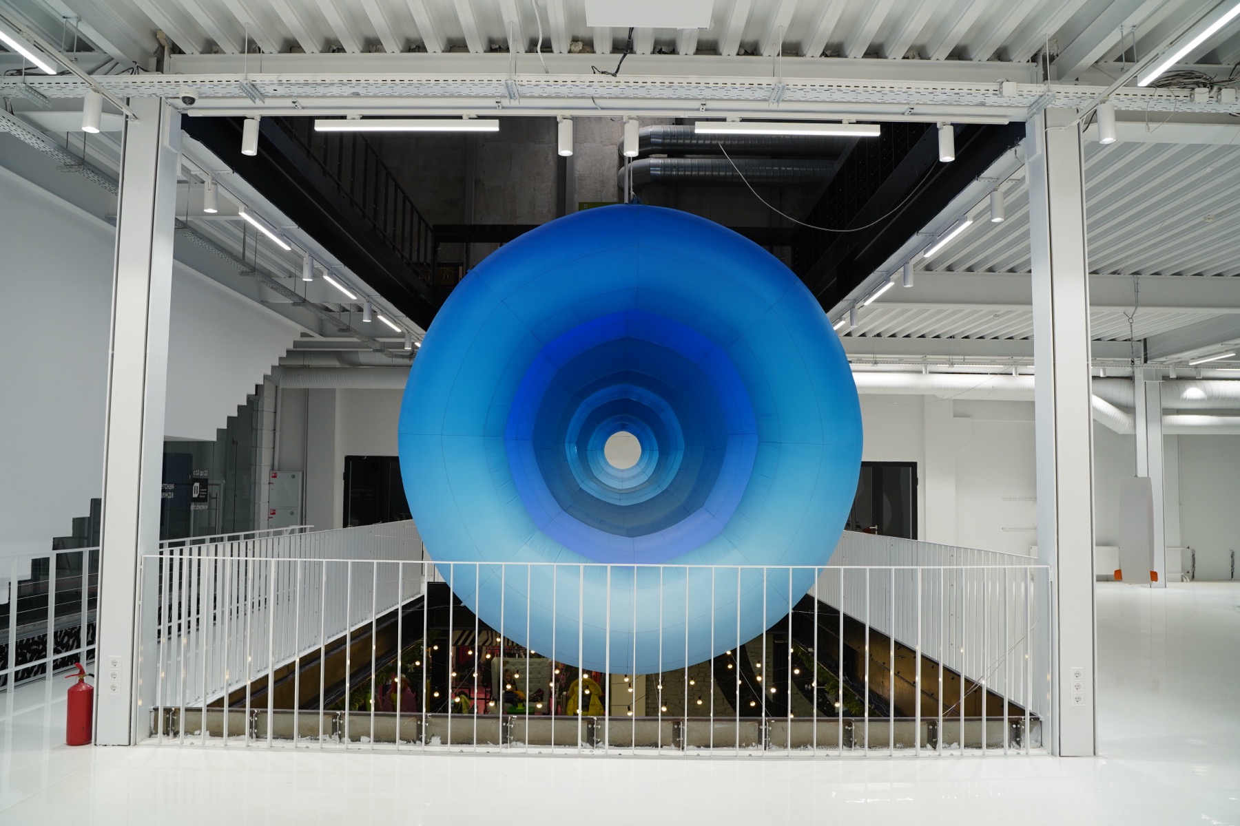 Frontal view into the circular opening of the blue inflatable 1=0 installation