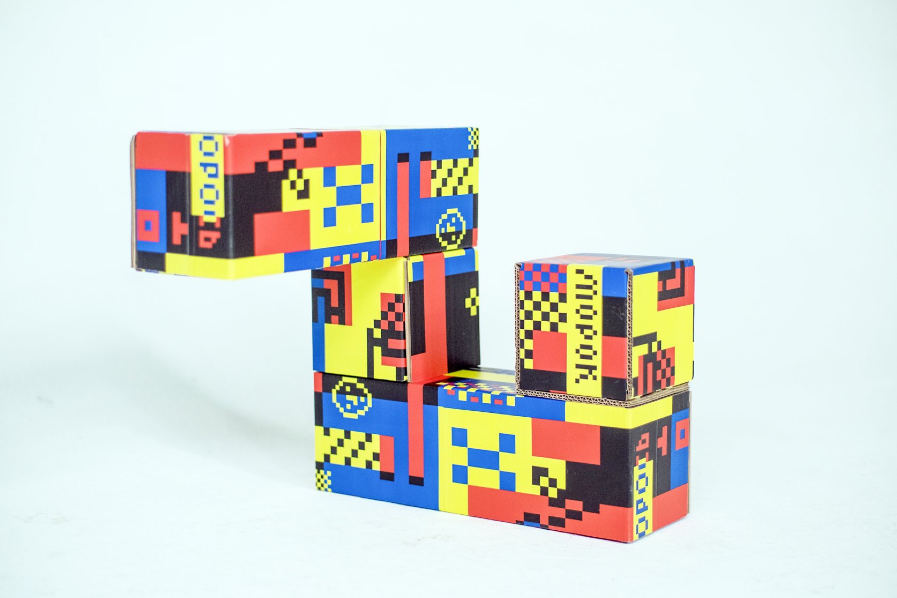 Separate Pangan Tetris cardboard modules showing printed geometric surfaces