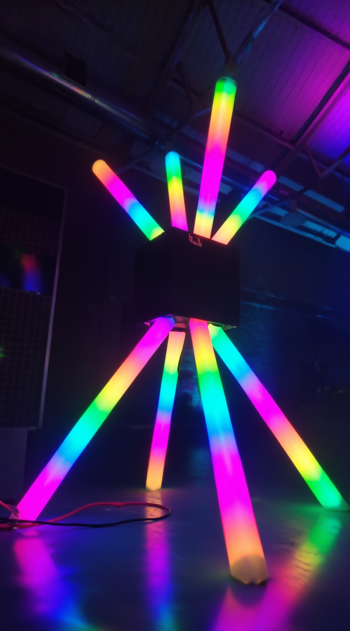 Compact POKE-N-CLICK with multicolored glowing tubes seen from below