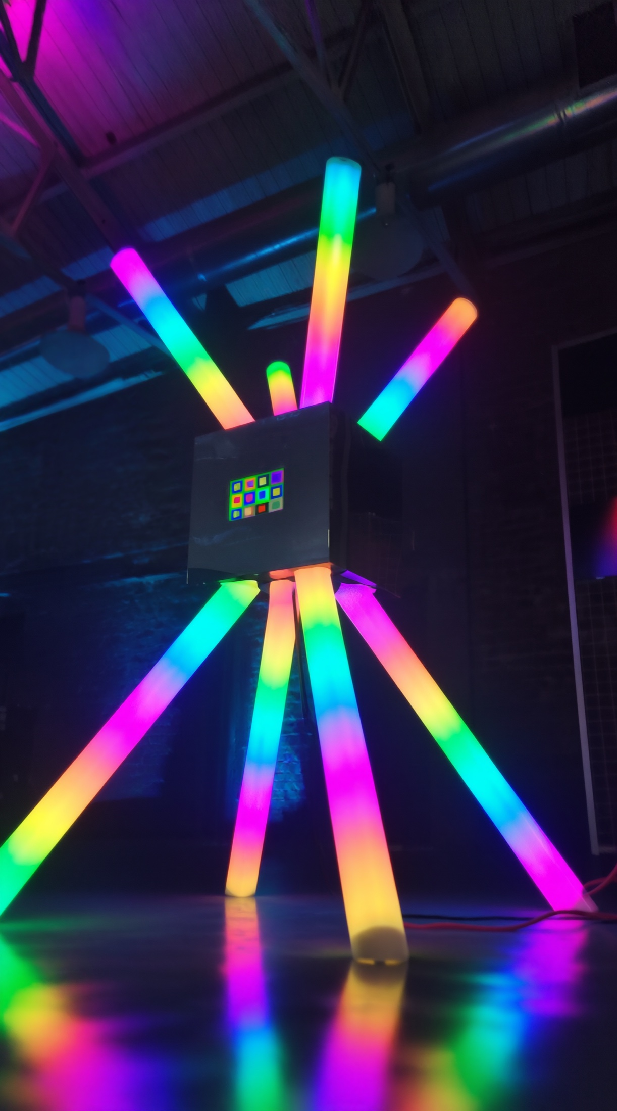 Compact POKE-N-CLICK standing on multicolored glowing tube legs