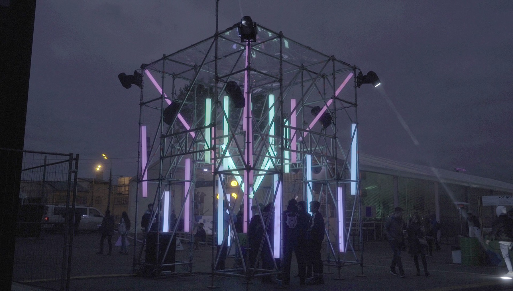 POKE-N-CLICK interactive light and sound installation at night with visitors nearby
