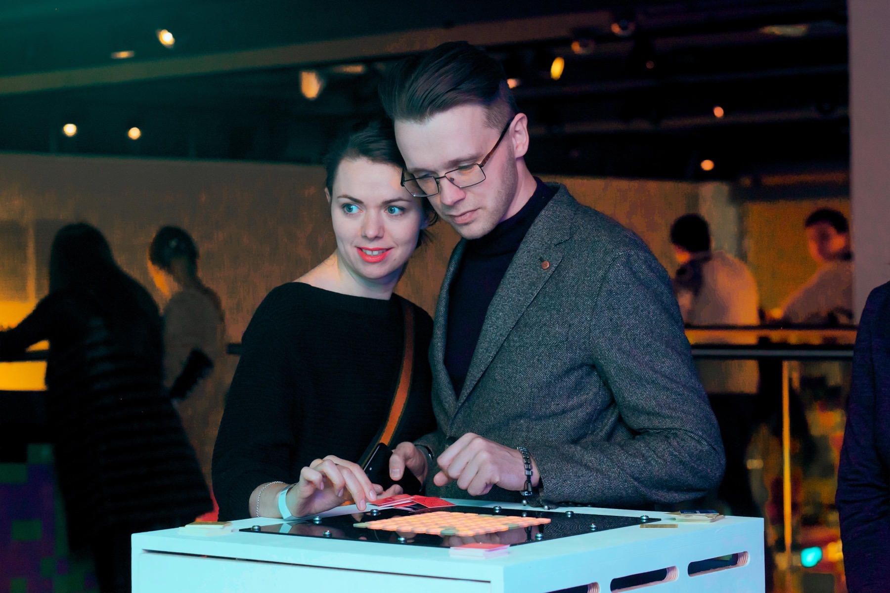Two visitors playing with the POKE-N-CLICK button interface