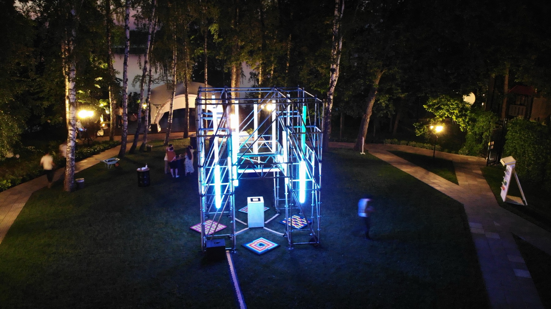 Aerial night view of POKE-N-CLICK installed outdoors with glowing lamps
