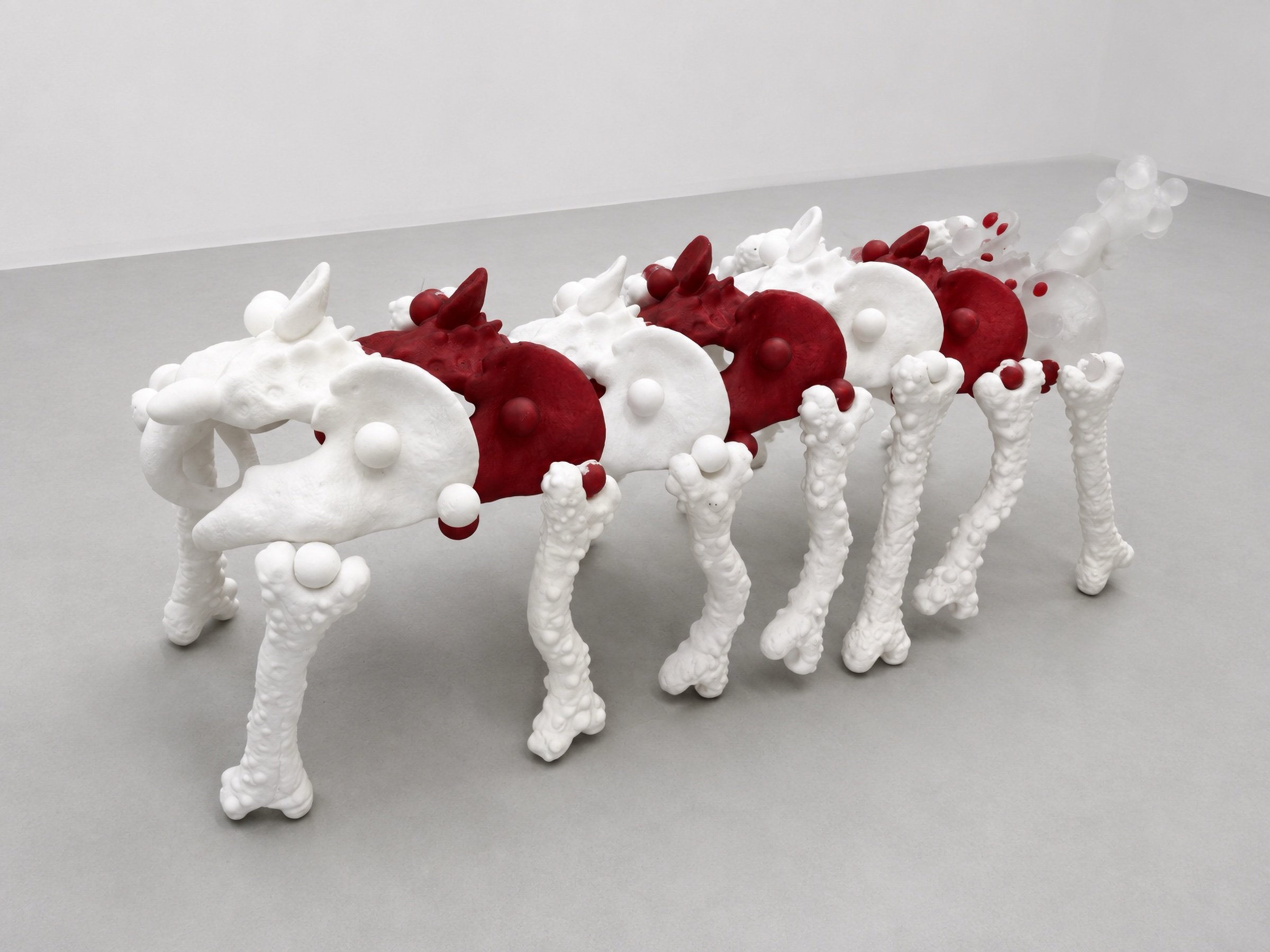 Long white and red Rebone organizm'os organism assembled on multiple bone-like legs