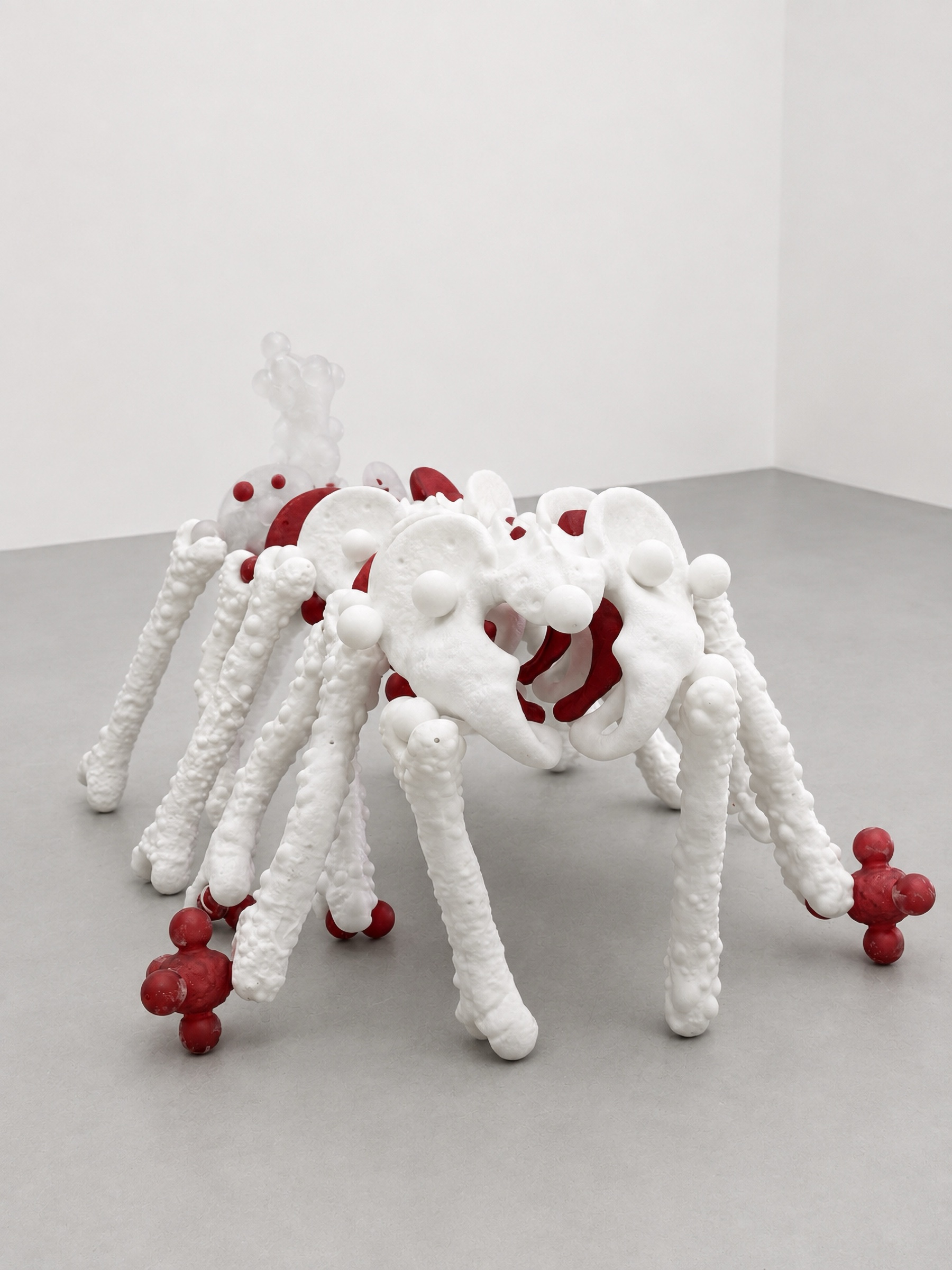 Front view of the white and red multi-legged Rebone organizm'os organism