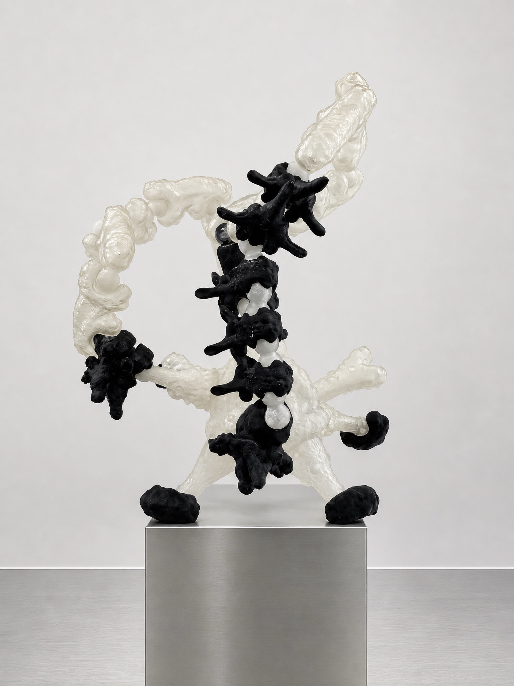 Black and translucent Rebone organizm’os form on a metal plinth