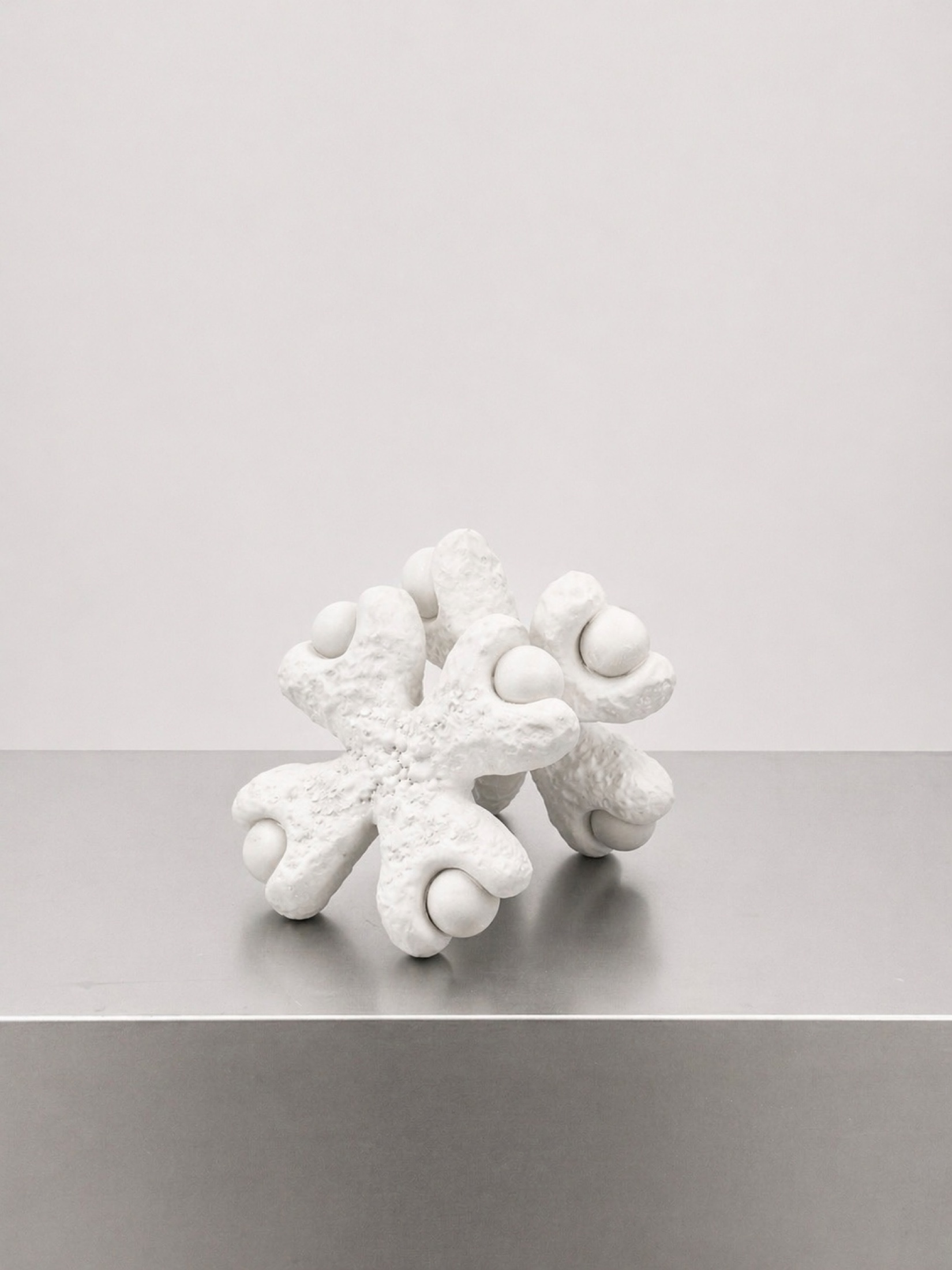 Single white Rebone organizm'os module resting on a metal surface
