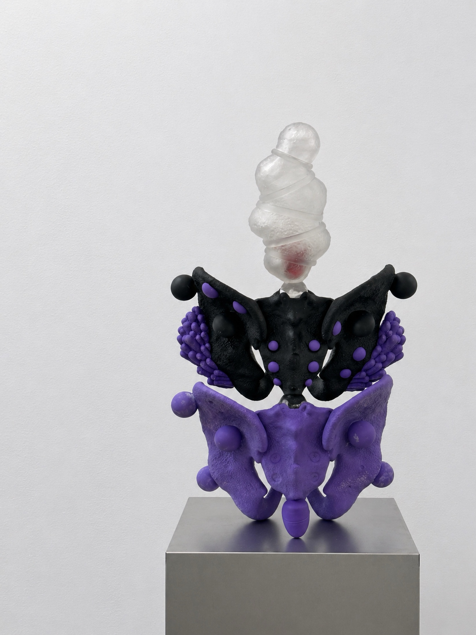 Black and purple Rebone organizm’os pelvis-like structure on a metal plinth
