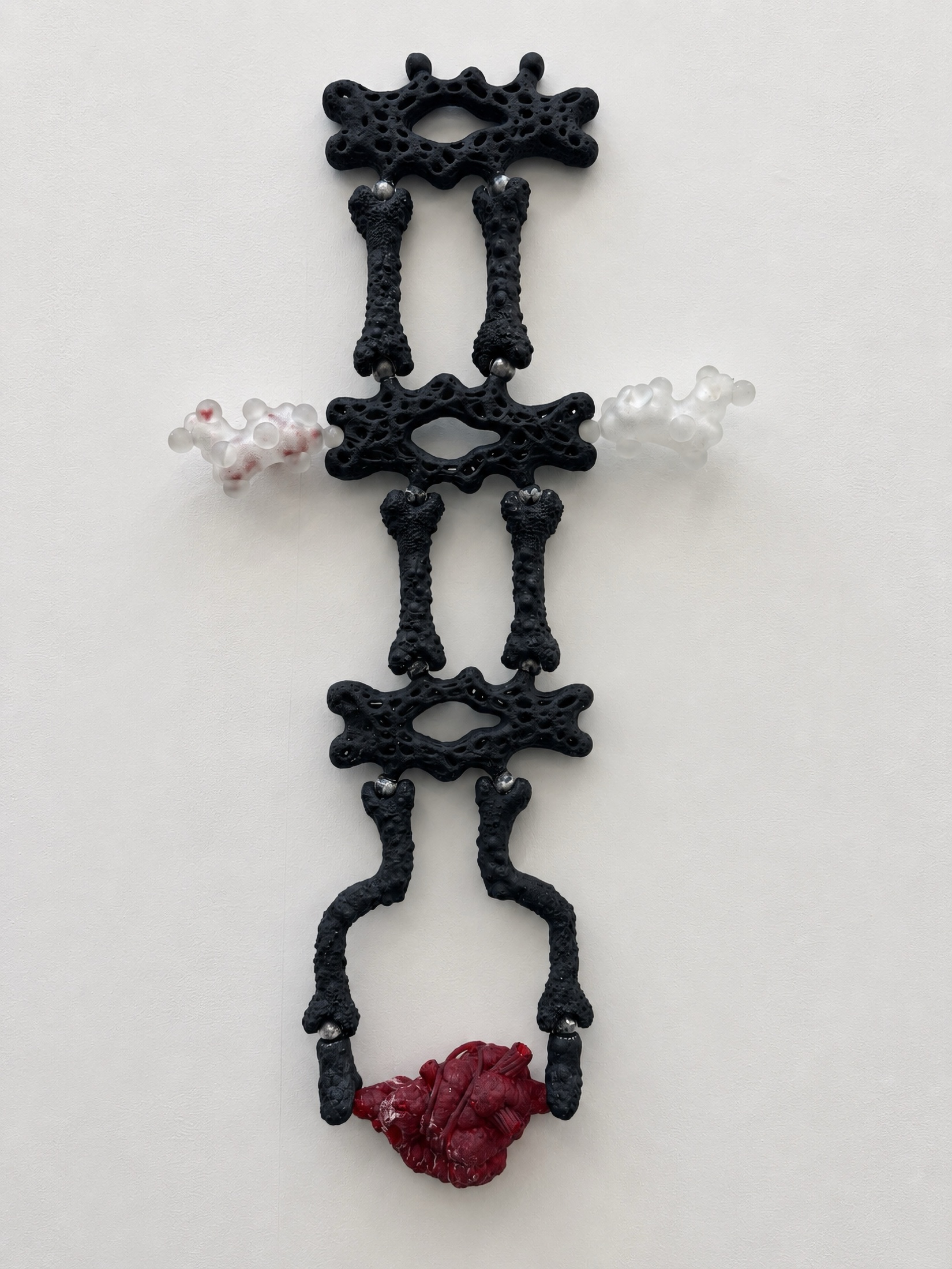 Black Rebone organizm’os wall-like skeletal structure with red organ at the bottom