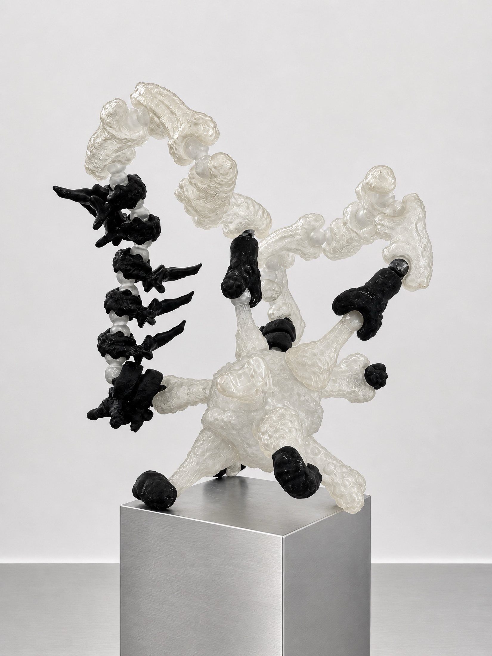 Black and translucent Rebone organizm’os structure on a metal plinth
