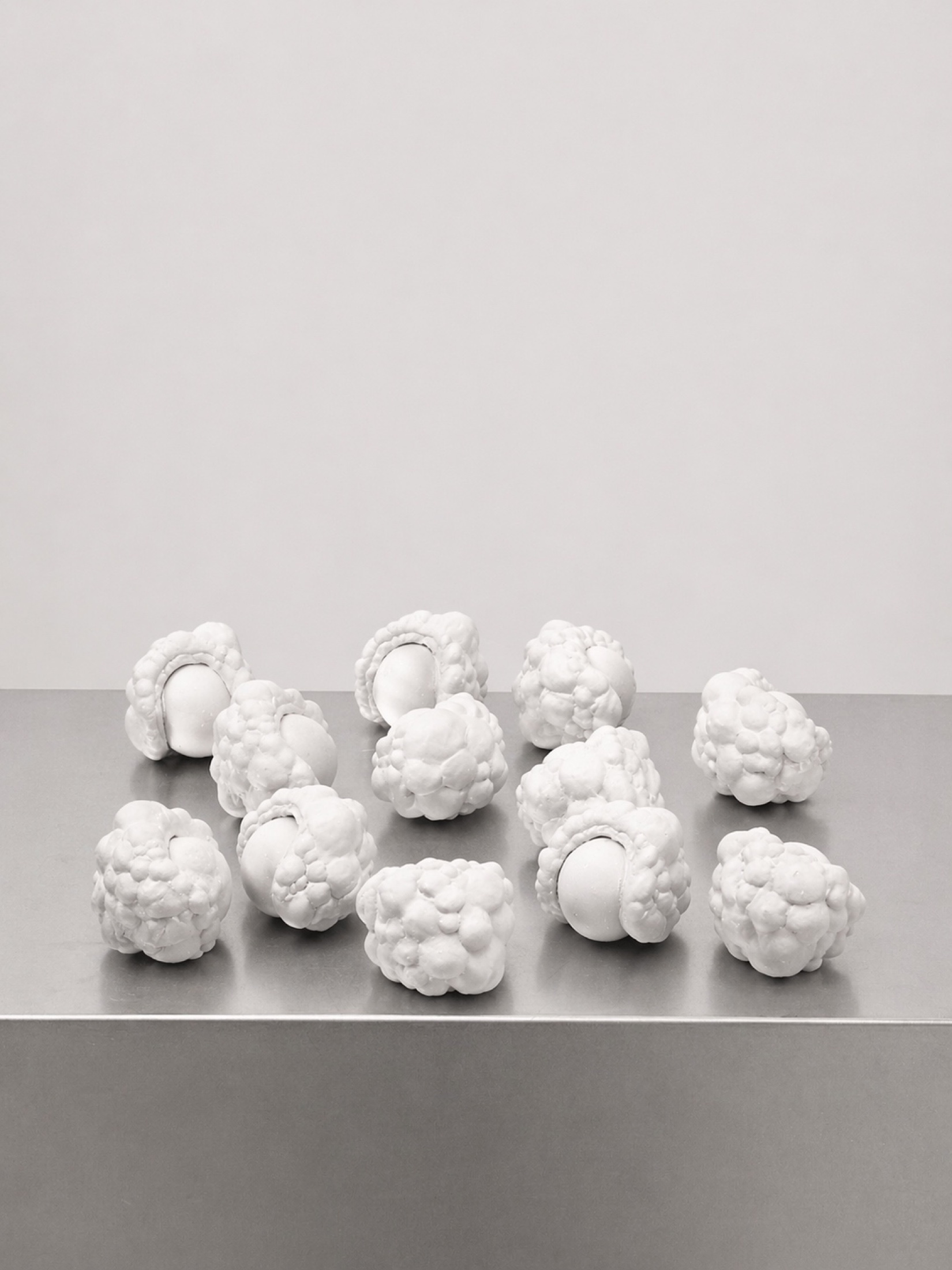 White modular Rebone organizm’os elements arranged on a metal plinth