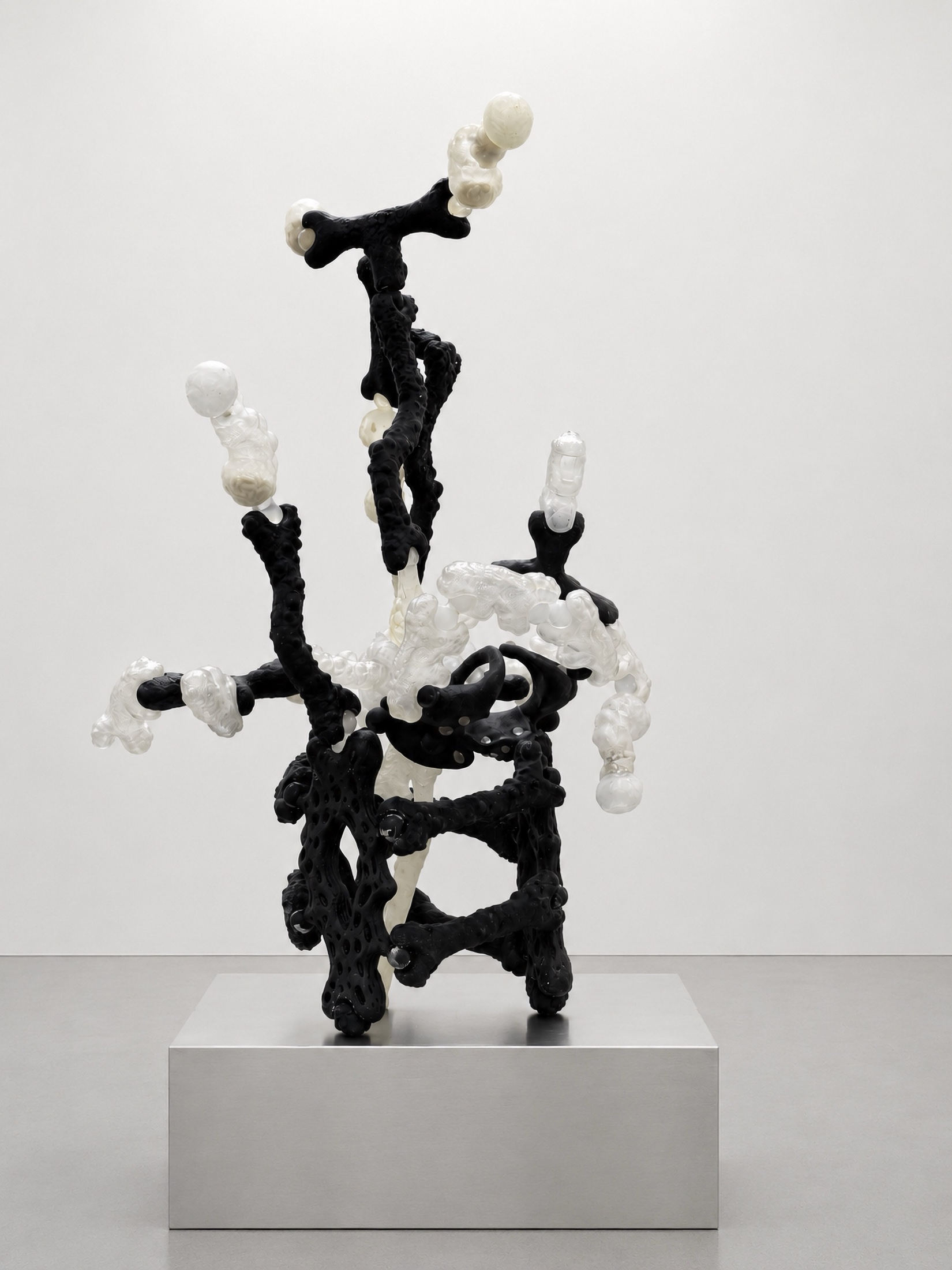 Tall black and translucent Rebone organizm’os structure on a metal plinth