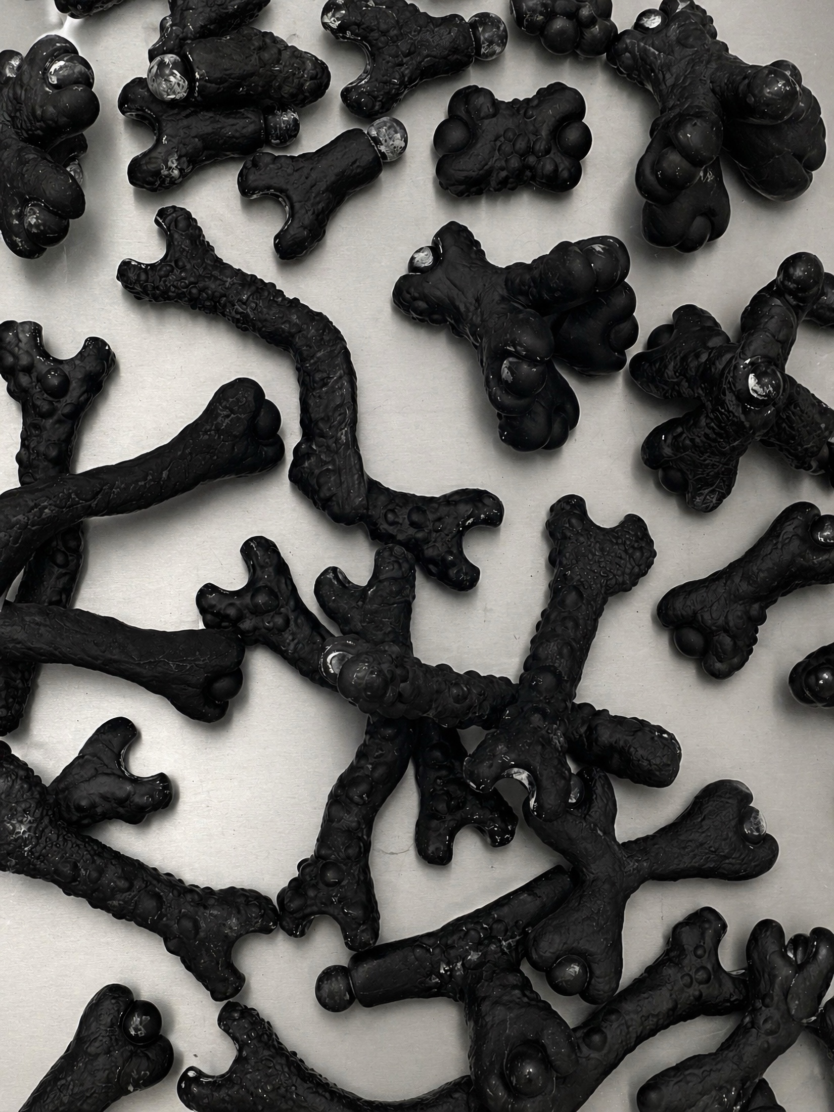 Black Rebone organizm'os modular components spread on a metal surface