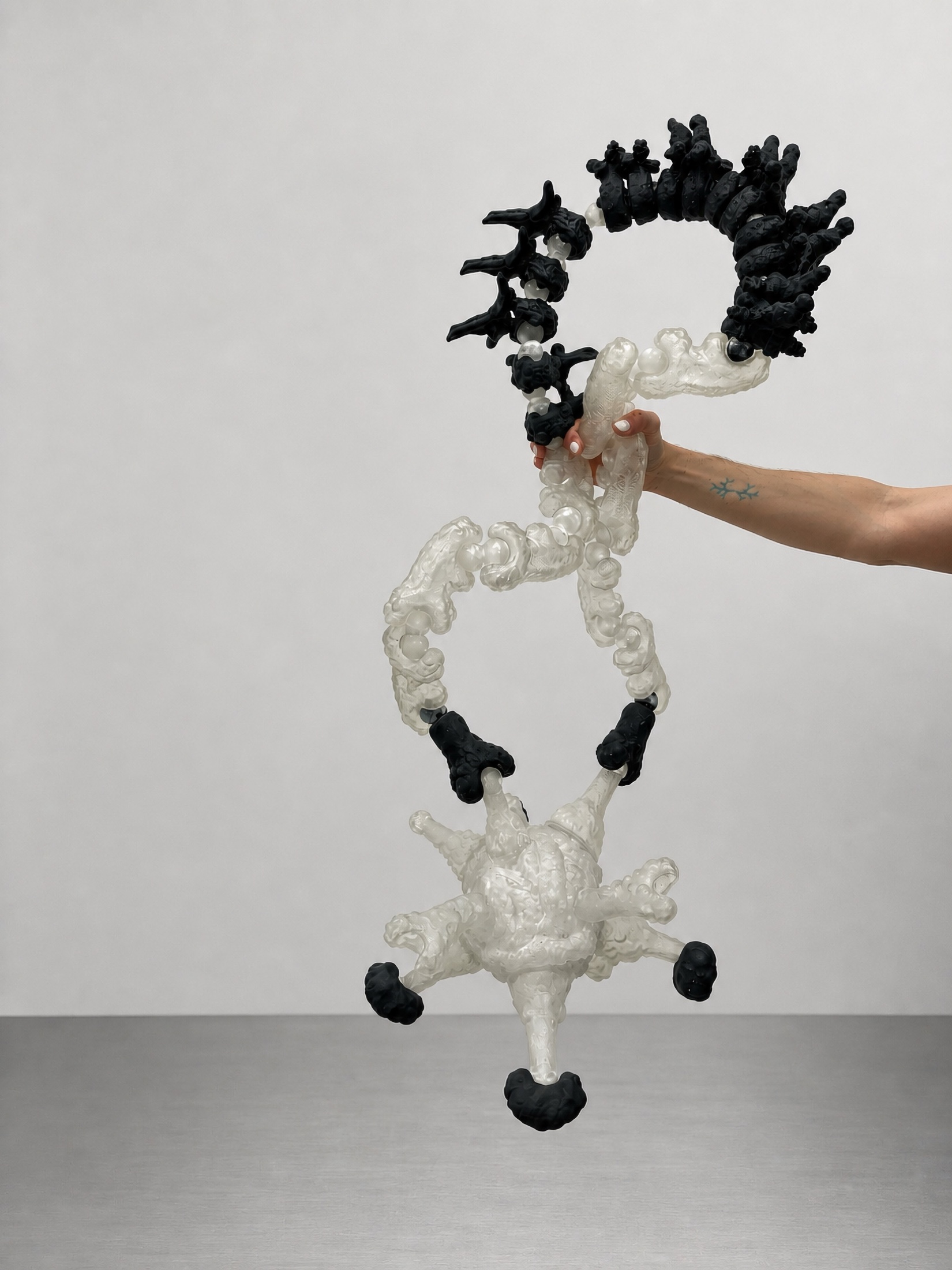 Rebone organizm'os suspended modular organism held by a hand