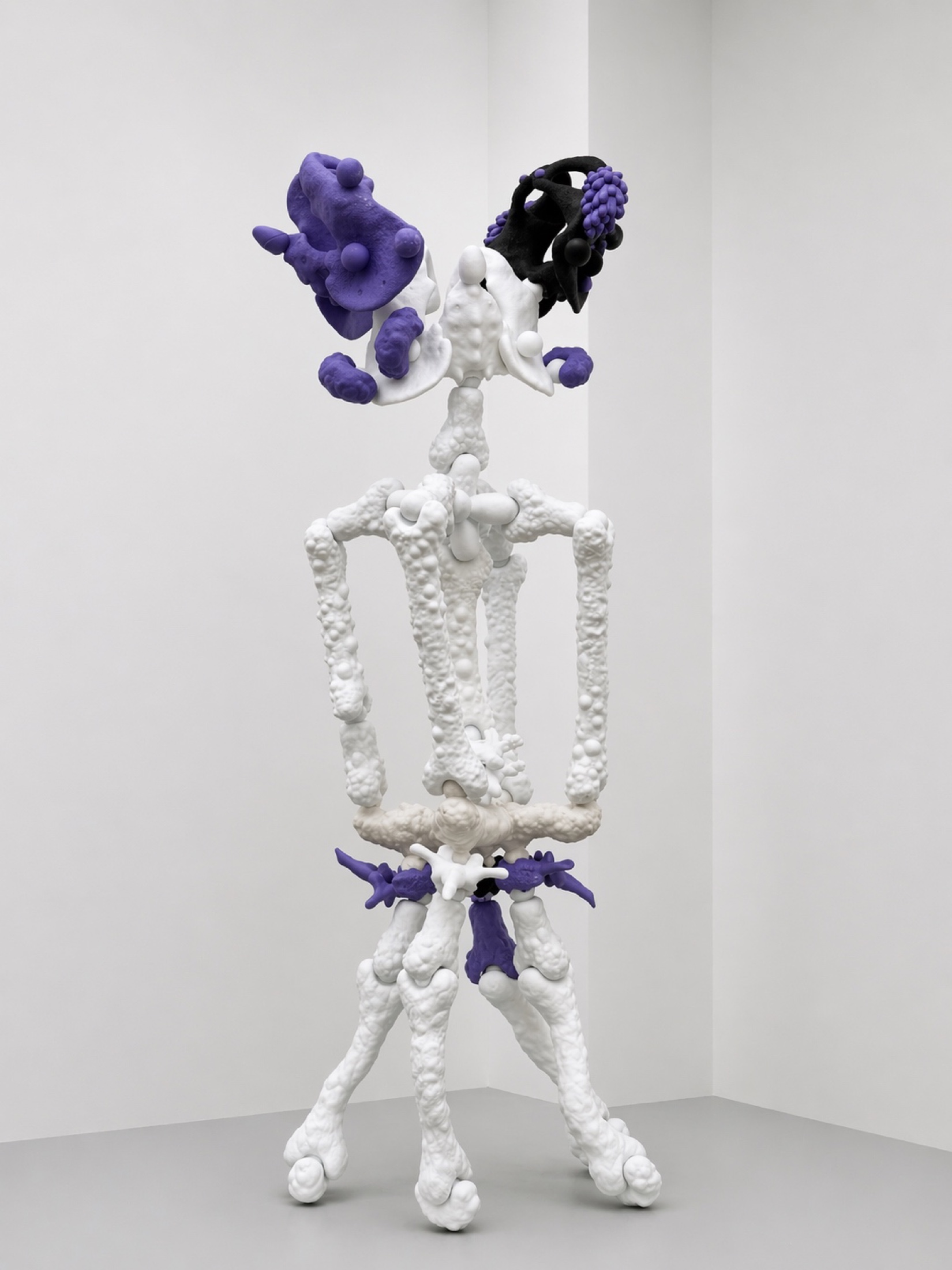 Tall white Rebone organizm'os skeletal structure with purple elements