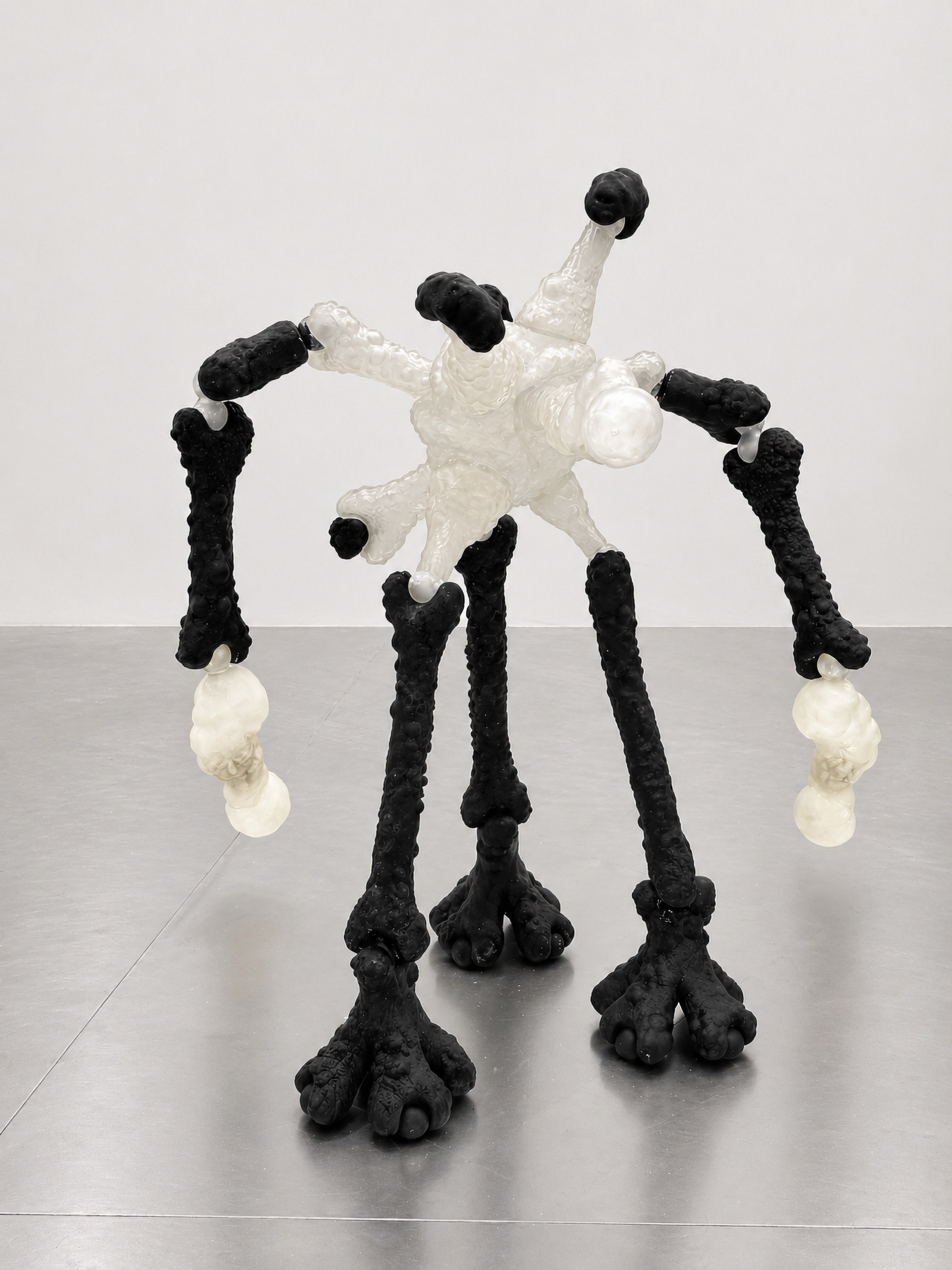 Tall black and translucent Rebone organizm'os organism standing on a metal surface