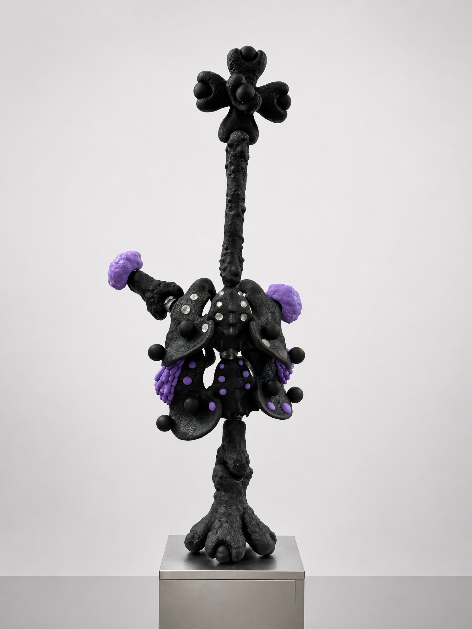 Tall black Rebone organizm'os figure with purple organs on a metal plinth