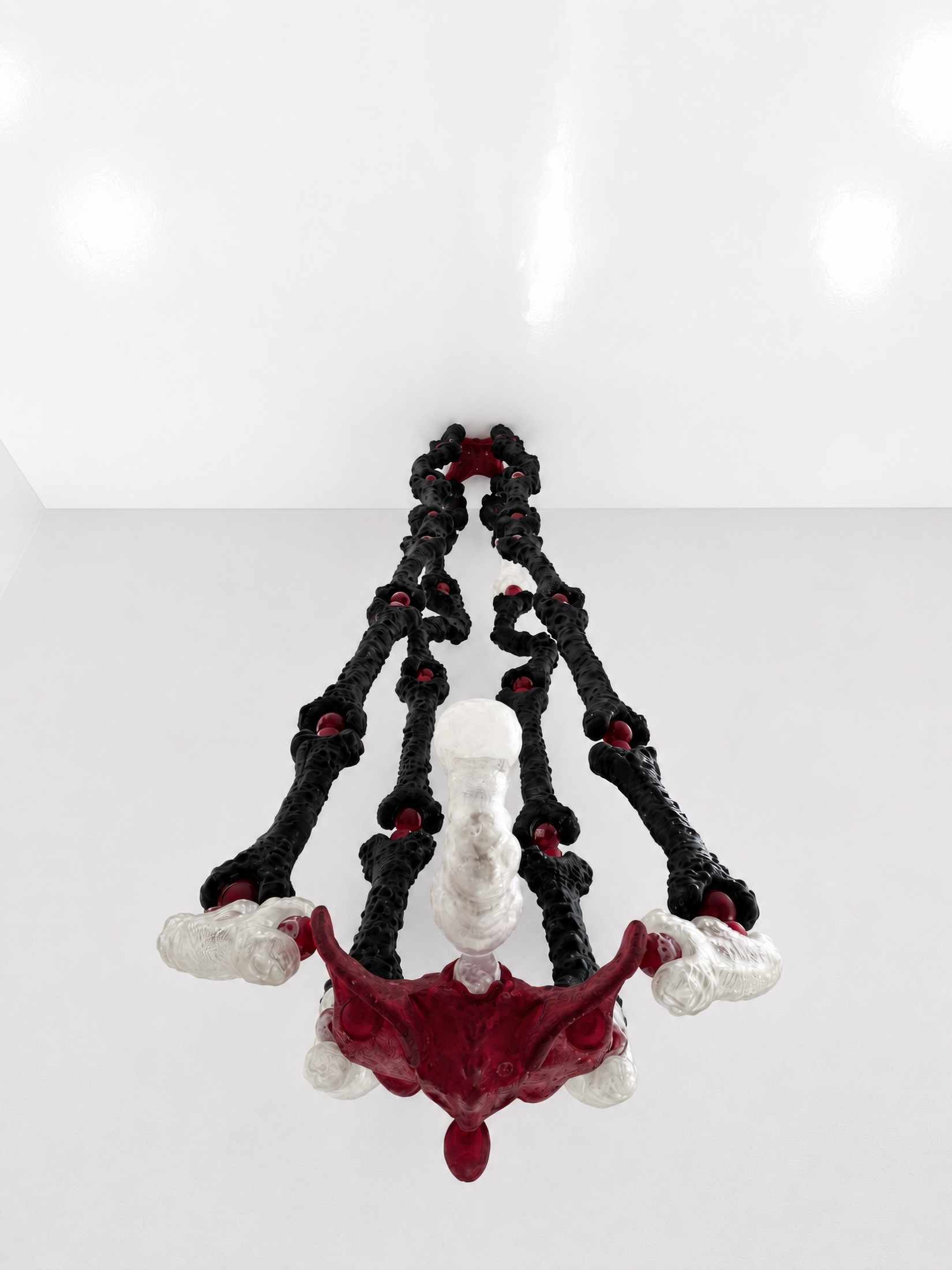 Low-angle view of a black, red, and translucent Rebone organizm'os figure